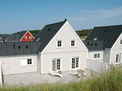 a white barn with a black roof at Holiday Home Ønef - 1km from the sea by Interhome in Blokhus