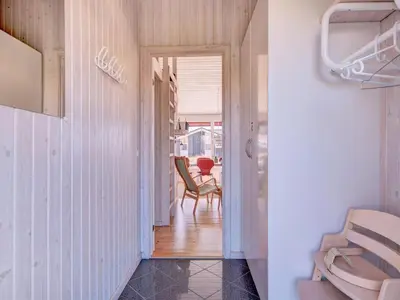 a hallway with chairs and a table in a room at Holiday Home Nedelko - 250m from the sea by Interhome in Blokhus