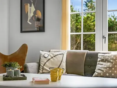 a living room with a couch and a table at Holiday Home Ingmarie - 1km from the sea by Interhome in Blokhus