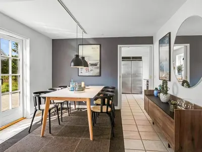 a dining room with a table and chairs at Holiday Home Ingmarie - 1km from the sea by Interhome in Blokhus