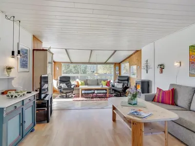 a living room with a couch and a table at Holiday Home Ingebritt - 1-5km from the sea by Interhome in Blokhus
