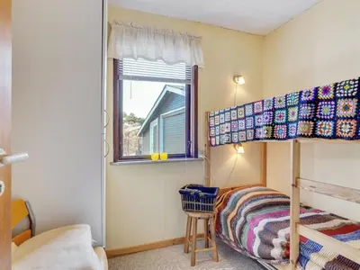 a bedroom with a bunk bed and a window at Holiday Home Ingebritt - 1-5km from the sea by Interhome in Blokhus