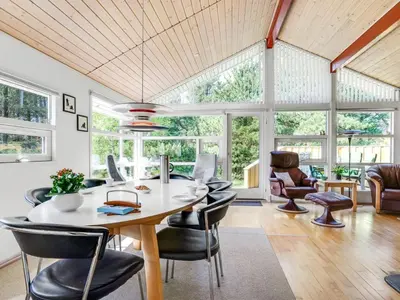 a dining room with a table and chairs at Holiday Home Vetle - 2-8km from the sea by Interhome in Blokhus