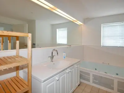 a bathroom with a sink and a bath tub at Holiday Home Stine - 1km from the sea by Interhome in Blokhus