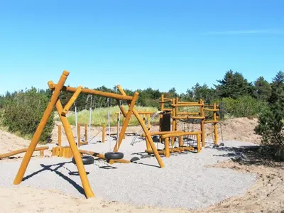 a wooden playground in the sand on a beach at Holiday Home Stine - 1km from the sea by Interhome in Blokhus