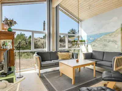 a living room with a couch and a table at Holiday Home Felizia - 2-5km from the sea by Interhome in Blokhus
