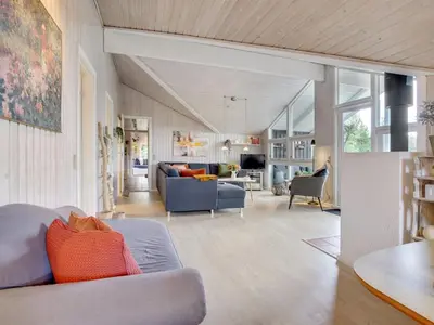 a living room with a blue couch and a table at Holiday Home Elayne - 3km from the sea by Interhome in Blokhus
