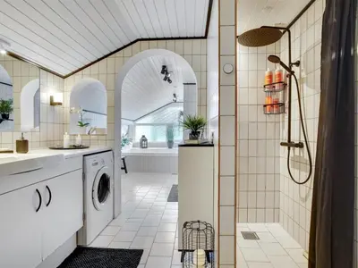 a bathroom with a washing machine and a shower at Holiday Home Elayne - 3km from the sea by Interhome in Blokhus