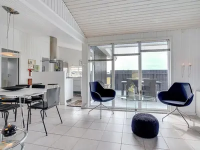 a kitchen and dining room with a table and chairs at Holiday Home Arwen - 200m from the sea by Interhome in Blokhus