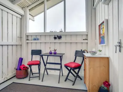a patio with a table and four chairs at Holiday Home Arwen - 200m from the sea by Interhome in Blokhus