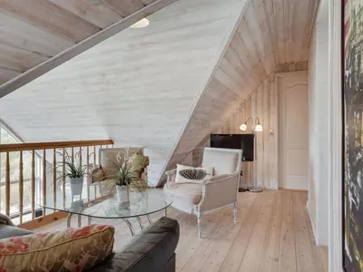 a living room with a couch and a glass table at Holiday Home Maren - 150m from the sea by Interhome in Blokhus