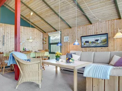 a living room with a couch and a table at Holiday Home Alfrik - 900m from the sea by Interhome in Blokhus