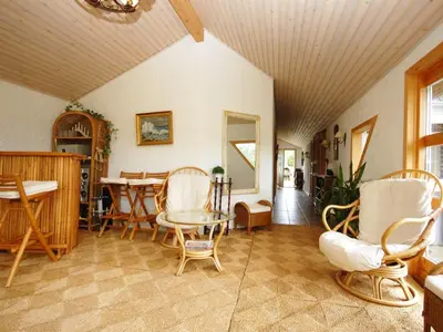 a living room with chairs and a table at Holiday Home Tajo - 1km from the sea by Interhome in Blokhus