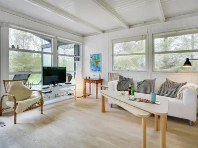 a living room with a couch and a tv at Holiday Home Bernadeta - 1-2km from the sea by Interhome in Blokhus