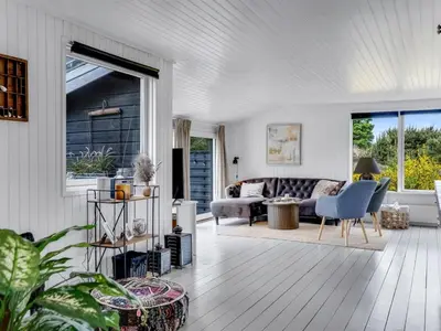 a living room with a couch and a table at Holiday Home Noralee - 3-5km from the sea by Interhome in Blokhus
