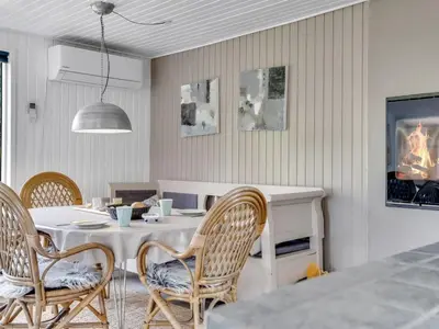 a dining room with a white table and chairs at Holiday Home Noralee - 3-5km from the sea by Interhome in Blokhus