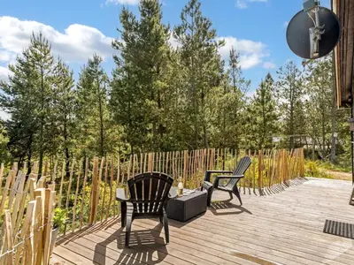 two chairs and a table on a wooden deck at Holiday Home Noralee - 3-5km from the sea by Interhome in Blokhus