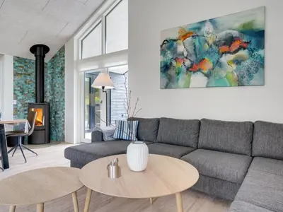 a living room with a couch and a table at Holiday Home Antonina - 800m from the sea by Interhome in Blokhus