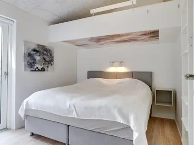 a white bedroom with a large bed in it at Holiday Home Antonina - 800m from the sea by Interhome in Blokhus