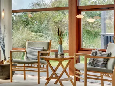 a room with two chairs and a table and a window at Holiday Home Friderike - 200m from the sea by Interhome in Blokhus