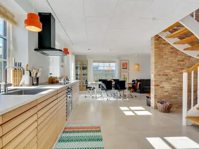 a kitchen with a sink and a living room at Holiday Home Shiva - 300m from the sea by Interhome in Blokhus