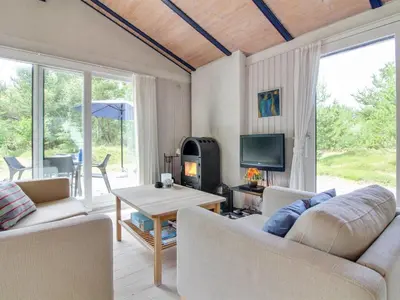 a living room with two couches and a fireplace at Holiday Home Heike - 1-3km from the sea by Interhome in Blokhus