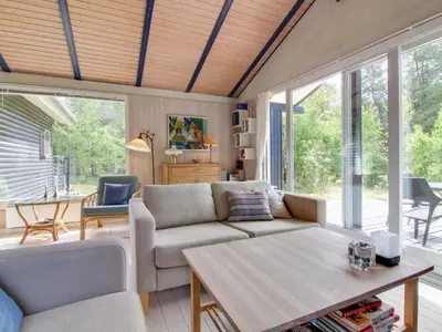a living room with a couch and a table at Holiday Home Heike - 1-3km from the sea by Interhome in Blokhus