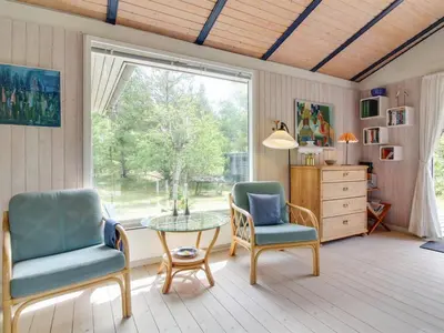 a living room with two chairs and a table and a window at Holiday Home Heike - 1-3km from the sea by Interhome in Blokhus