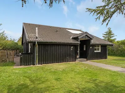a black house with a gambrel roof at Holiday Home Pelle - 800m from the sea by Interhome in Blokhus