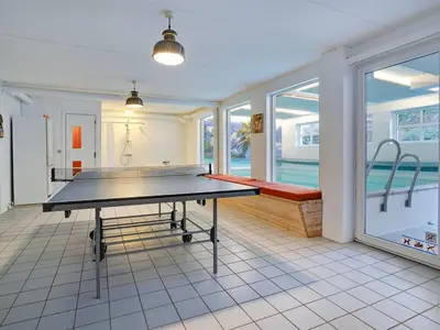 a ping pong table in the middle of a room at Holiday Home Pelle - 800m from the sea by Interhome in Blokhus