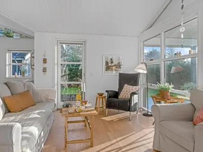 a living room with a couch and a table at Holiday Home Onta - 900m from the sea by Interhome in Blokhus