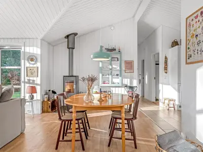 a dining room with a table and chairs at Holiday Home Onta - 900m from the sea by Interhome in Blokhus