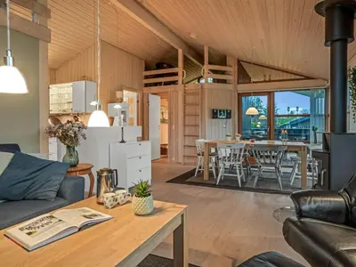 a living room with a couch and a table at Holiday Home Jelin - 2-5km from the sea by Interhome in Blokhus