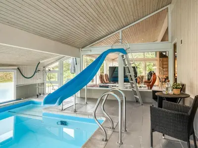 a house with a slide in the middle of a pool at Holiday Home Helene - 1-5km from the sea by Interhome in Blokhus