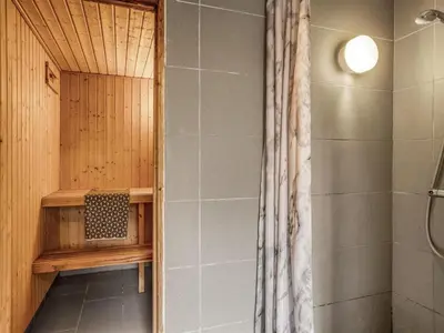 a bathroom with a shower and a shower curtain at Holiday Home Helene - 1-5km from the sea by Interhome in Blokhus