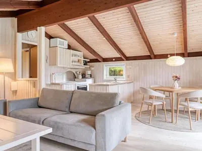 a living room with a couch and a table at Holiday Home Ingimar - 2-2km from the sea by Interhome in Blokhus