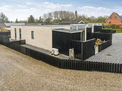 a building with a black fence in front of it at Holiday Home Klaudius - 2km from the sea by Interhome in Blokhus
