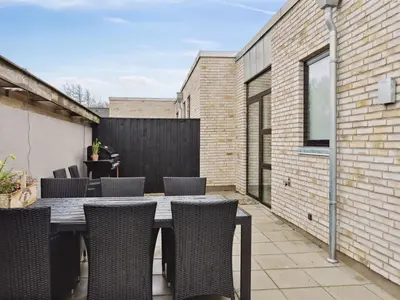 an outdoor patio with a table and chairs at Holiday Home Klaudius - 2km from the sea by Interhome in Blokhus
