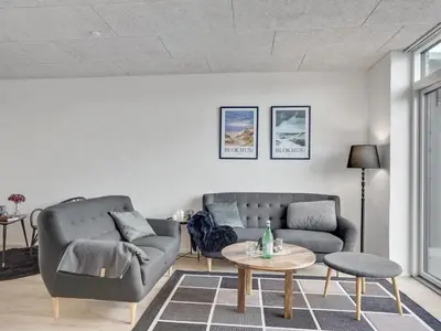 a living room with a couch and a table at Holiday Home Ilsabe - 2km from the sea by Interhome in Blokhus