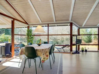 a dining room with a table and green chairs at Holiday Home Angja - 800m from the sea by Interhome in Blokhus