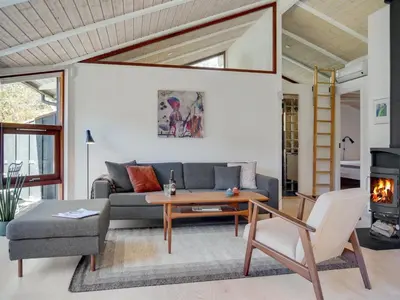 a living room with a couch and a table at Holiday Home Angja - 800m from the sea by Interhome in Blokhus