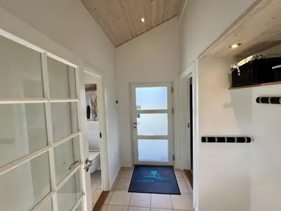 a hallway with a door leading to a bathroom at Holiday Home Ancel - 1-7km from the sea by Interhome in Blokhus