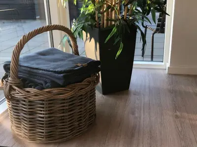 a basket of towels sitting next to a potted plant at Holiday Home Ancel - 1-7km from the sea by Interhome in Blokhus