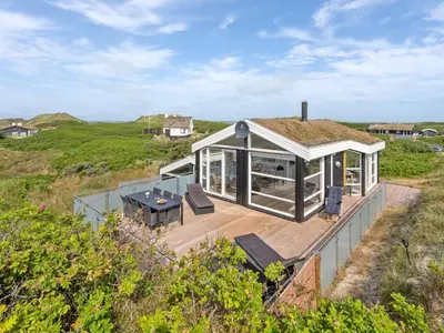 a house with a roof that has a deck at Holiday Home Swerting - 230m from the sea by Interhome in Saltum