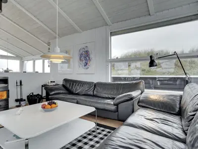 a living room with a couch and a table at Holiday Home Swerting - 230m from the sea by Interhome in Saltum