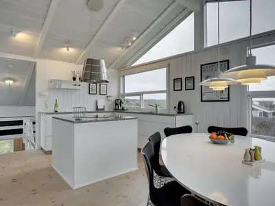 a kitchen with a large white table and chairs at Holiday Home Swerting - 230m from the sea by Interhome in Saltum