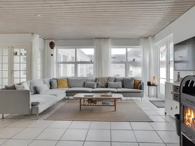 a living room with a couch and a table at Holiday Home Riki - 150m from the sea by Interhome in Blokhus