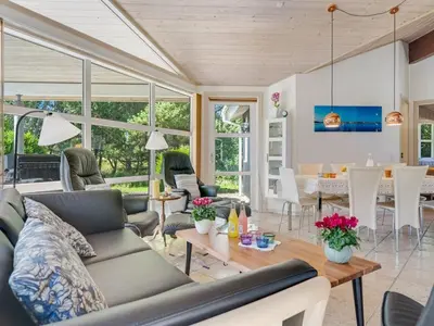 a living room with a couch and a table at Holiday Home Bina - 1-9km from the sea by Interhome in Blokhus