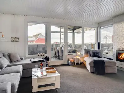 a living room with a couch and a fireplace at Holiday Home Kiina - 100m from the sea by Interhome in Blokhus