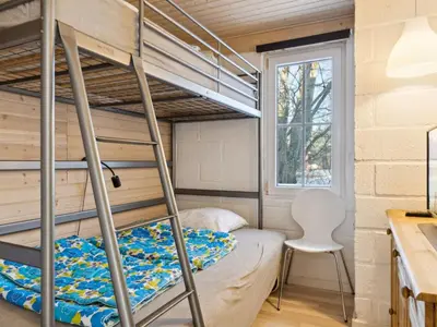 a bunk bed in a tiny house at Holiday Home Gerwin - 3km from the sea by Interhome in Blokhus